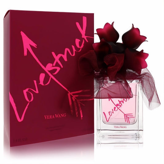 Vera Wang Lovestruck 3.4 oz EDP. Elegant clear bottle with pink liquid, red rose cap, and matching magenta box with arrow design.