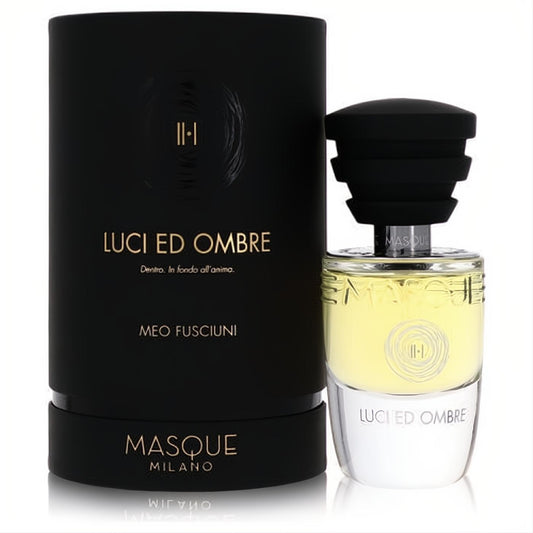 Elegant Masque Milano Luci Ed Ombre unisex EDP spray. Black box, clear glass bottle, captivating yellow fragrance, and black ribbed cap.