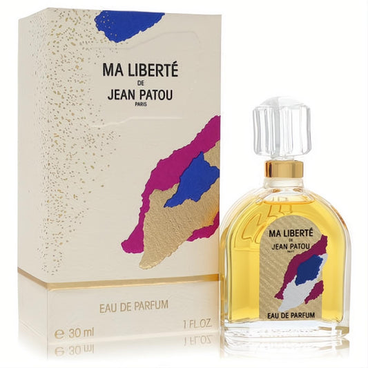 Ma Liberté Jean Patou 1 oz Eau de Parfum. Golden liquid in a clear, elegant bottle next to its chic cream box with vibrant abstract art.