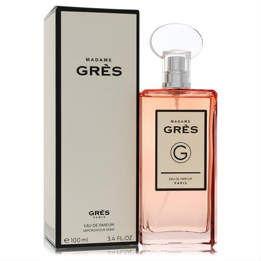 Sophisticated Madame Gres 3.4 oz Eau De Parfum spray. Clear glass bottle with delicate peach liquid and elegant beige branding box.