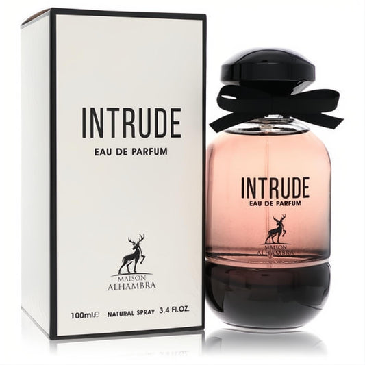 Maison Alhambra Intrude 3.4 oz EDP. Elegant pinkish-amber gradient glass bottle with black cap, ribbon, and white box.
