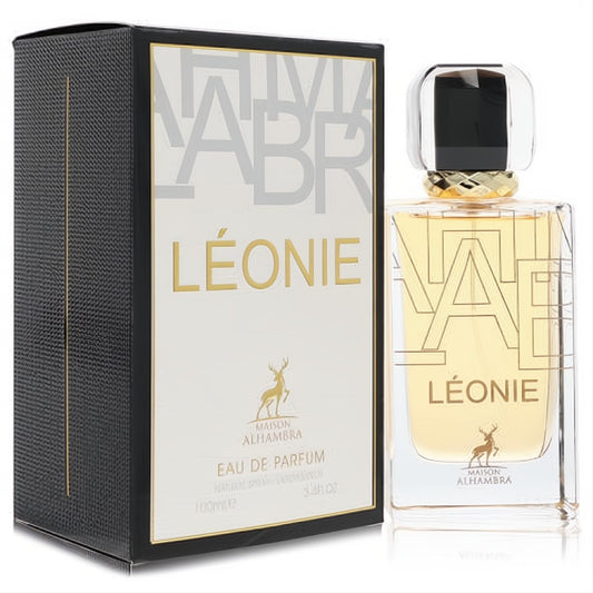Luxurious Maison Alhambra Leonie 3.4 oz unisex EDP. Sleek clear bottle with gold 'LÉONIE' text and a sophisticated black box.