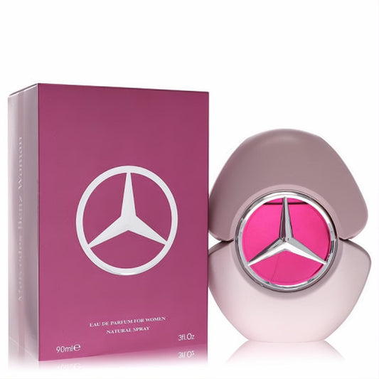Mercedes Benz Woman 3 oz EDP in a stylish pink bottle with silver star logo, beside its vibrant magenta box. A captivating fragrance.