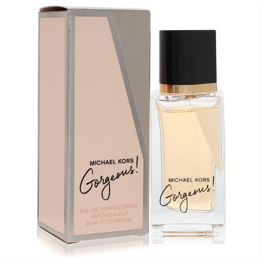 Michael Kors Gorgeous 1 oz Eau De Parfum spray. Luxurious clear glass bottle with golden liquid, sleek black cap, and elegant pink box.