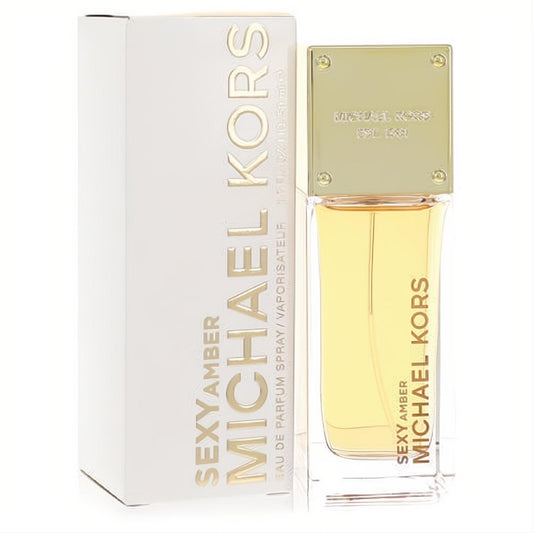 Luxurious Michael Kors Sexy Amber 1.7 oz EDP. Sleek clear glass bottle with rich amber liquid, gold cap, and elegant white branded box.