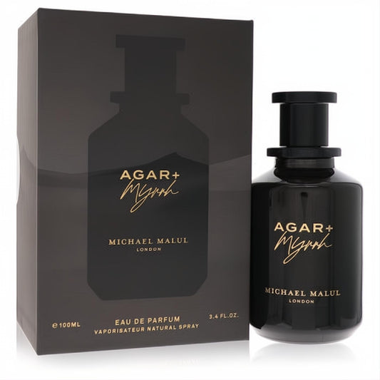 Michael Malul Agar + Myrrh 3.4 oz unisex Eau De Parfum. Sleek black bottle with gold script, next to its elegant matching box.