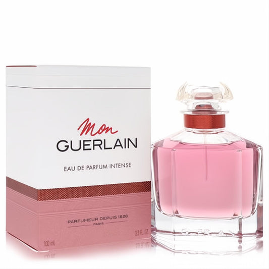 Mon Guerlain Intense 3.3 oz EDP for women. Clear faceted glass bottle with alluring pink fragrance, next to its stylish white and copper-toned box.