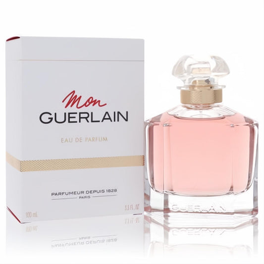 Mon Guerlain 3.3 oz women's Eau De Parfum. Elegant clear glass bottle with delicate pink fragrance, gold neck, and white box.