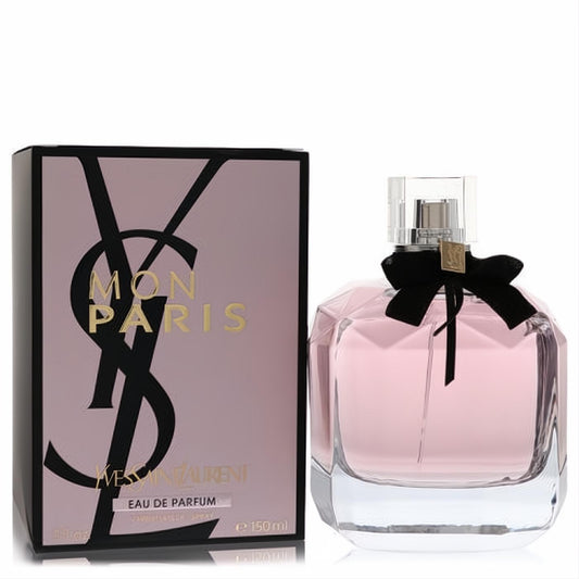 Luxurious YSL Mon Paris 5 oz Eau De Parfum spray. Pink fragrance in a faceted glass bottle with black bow and gold charm, next to its elegant box.