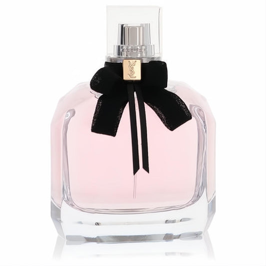 Mon Paris YSL Eau De Parfum spray: elegant faceted glass bottle, soft pink fragrance, chic black velvet bow with gold logo.