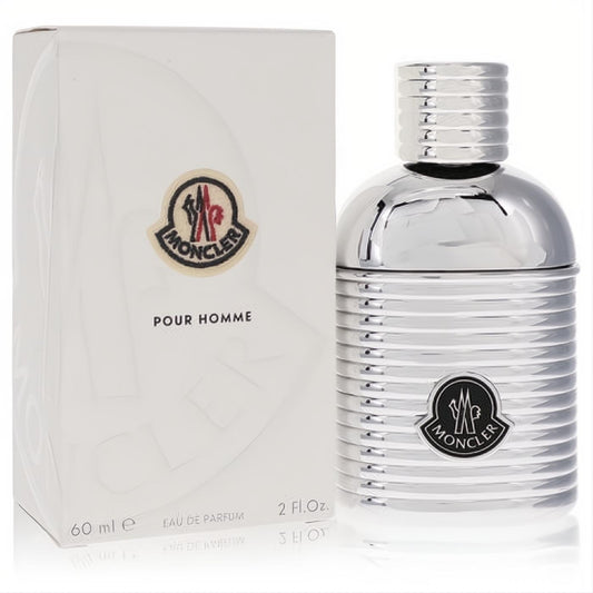 Luxurious Moncler Pour Homme 2 oz Eau De Parfum spray. Sleek silver ribbed bottle with iconic logo, beside a crisp white box.