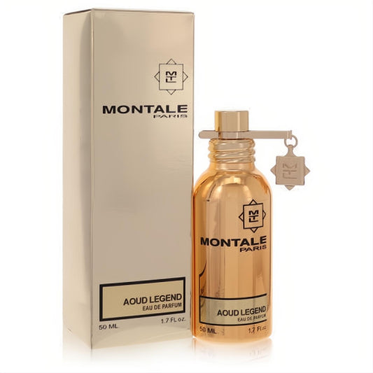Elegant gold Montale Aoud Legend 1.7 oz unisex Eau De Parfum bottle with charm, next to its sophisticated light gold box.