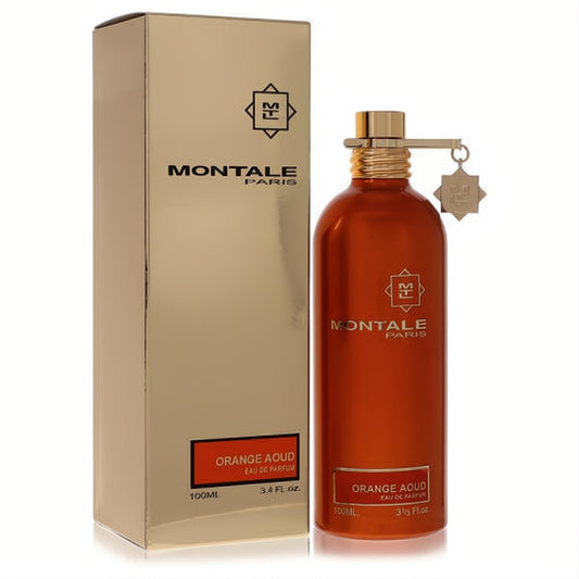 Sleek orange metallic Montale Orange Aoud 3.4 oz Eau De Parfum bottle with gold cap, next to its luxurious gold box.