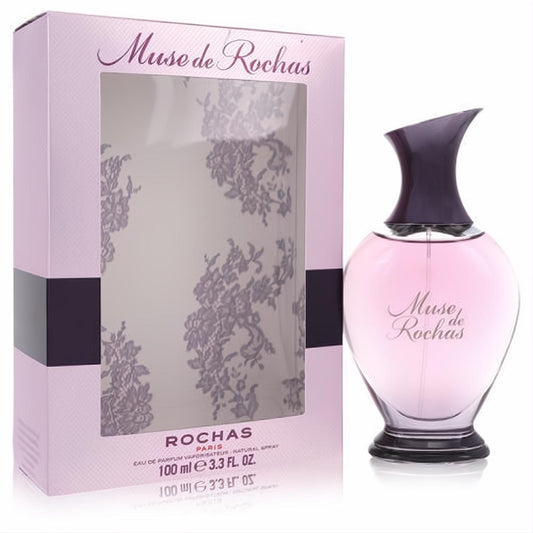 Muse de Rochas 3.3 oz Eau de Parfum. Elegant pink bottle with unique dark purple cap and a chic lace-patterned gift box.