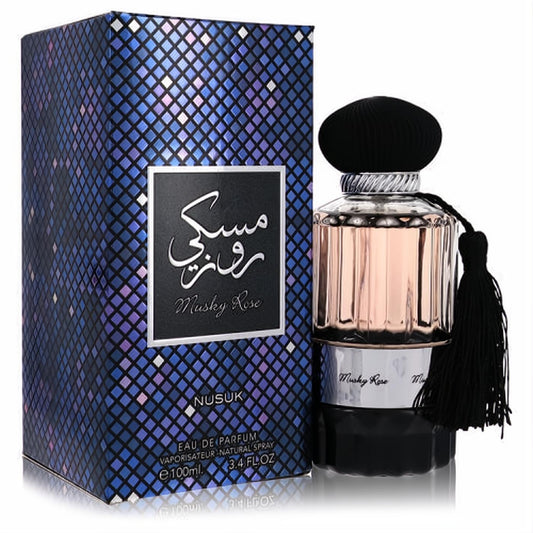 Nusuk Musky Rose 3.4 oz EDP. Elegant ribbed glass bottle with rose liquid, black cap, tassel, and shimmering blue mosaic box.
