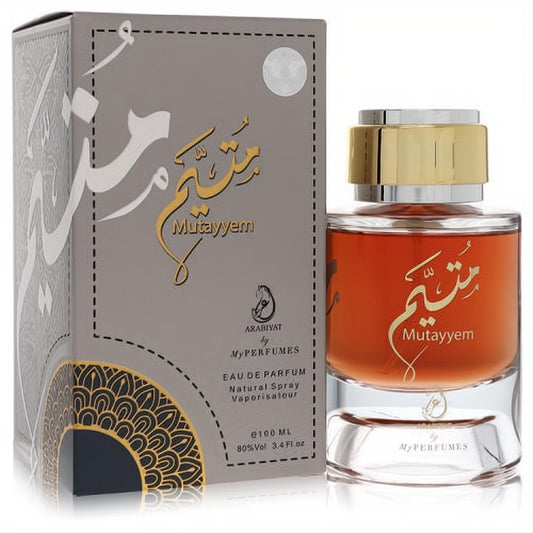 Luxurious Mutayyem by My Perfumes 3.4 oz men's EDP. Amber fragrance in a clear glass bottle with gold cap, beside its ornate grey and gold box.