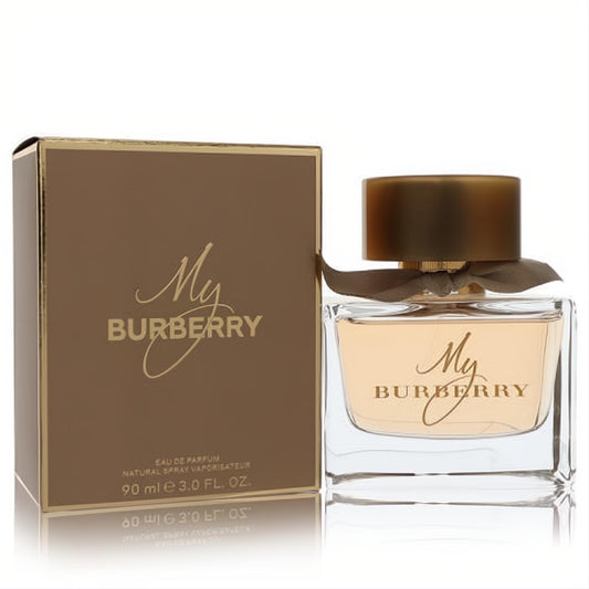 My Burberry 3 oz Eau De Parfum for women. Elegant clear glass bottle with brown cap and ribbon, next to its luxurious gold box.
