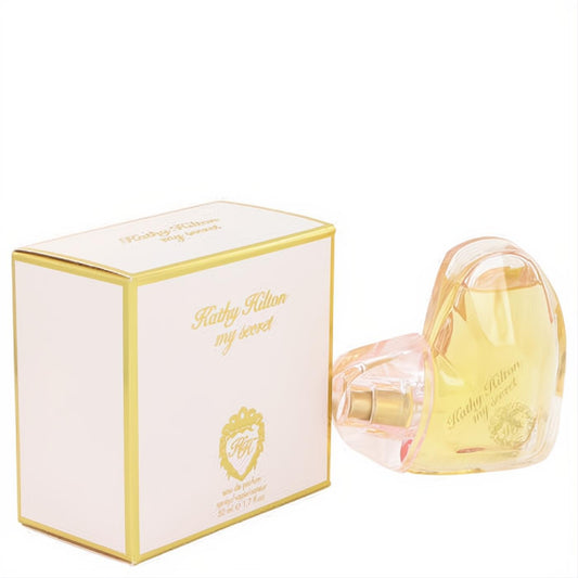 Kathy Hilton My Secret 1.7 oz EDP. Elegant heart-shaped bottle with pink base, gold accents, and a matching cream & gold box.