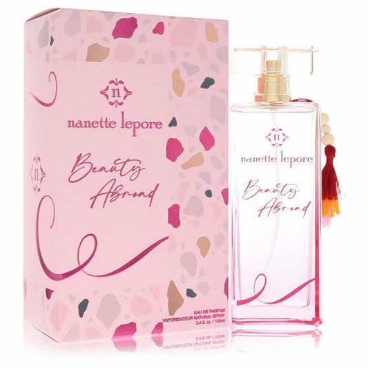 Chic Nanette Lepore Beauty Abroad 3.4 oz pink EDP spray bottle with gold cap, beaded tassel, and vibrant terrazzo-patterned box.