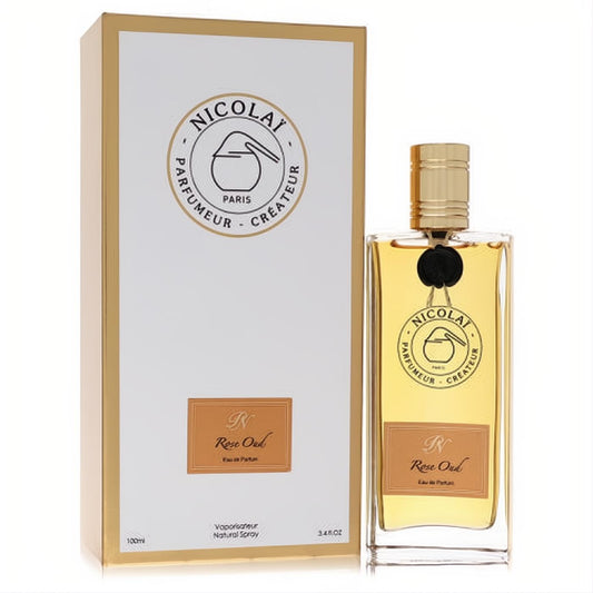 Luxurious Nicolai Rose Oud 3.4 oz unisex EDP. Golden liquid in a clear bottle with gold cap, beside an elegant white and gold box.