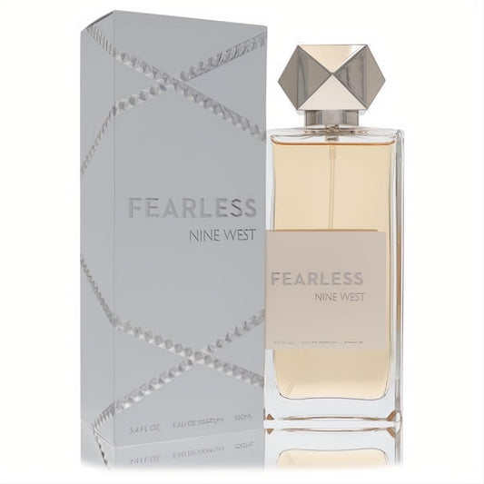 Elegant Nine West Fearless 3.4 oz Eau De Parfum. Clear bottle with golden liquid, striking silver geometric cap, and textured silver box.