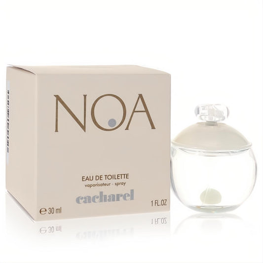 Elegant Cacharel Noa 1 oz women's EDT spray: clear glass bottle with pearl detail, beside its chic beige box.