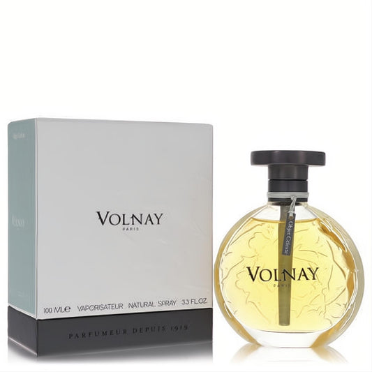 Volnay Objet Celeste 3.4 oz Eau De Parfum: elegant round glass bottle with golden liquid, black cap, and white branded box.