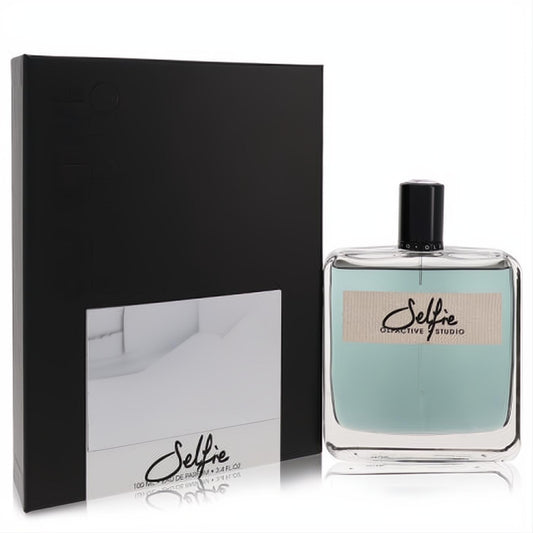 Olfactive Studio Selfie 3.4 oz unisex EDP. Modern clear glass bottle with light blue fragrance, beige label, and sleek matte black box.