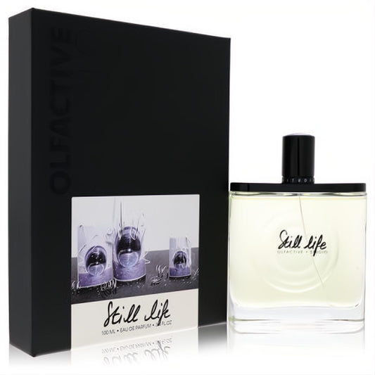 Sophisticated Olfactive Studio Still Life 3.4 oz unisex EDP. Clear glass bottle, black cap, sleek box with unique art.