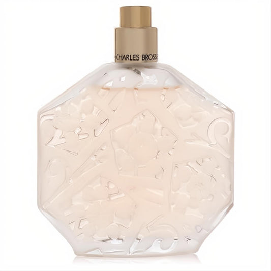 Elegant Ombre Rose perfume bottle: faceted clear glass with intricate floral etching, gleaming gold cap, and delicate pink fragrance.