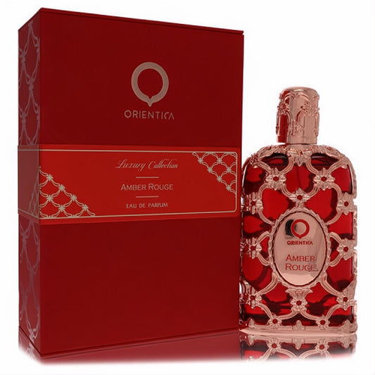 Orientica Amber Rouge 5 oz unisex Eau de Parfum spray in a luxurious red bottle with intricate rose gold filigree design and matching box.
