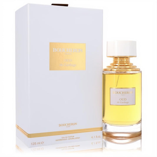 Exquisite Boucheron Oud De Carthage 4.1 oz EDP. Clear glass bottle with elegant gold cap & neck, next to its white & gold box.