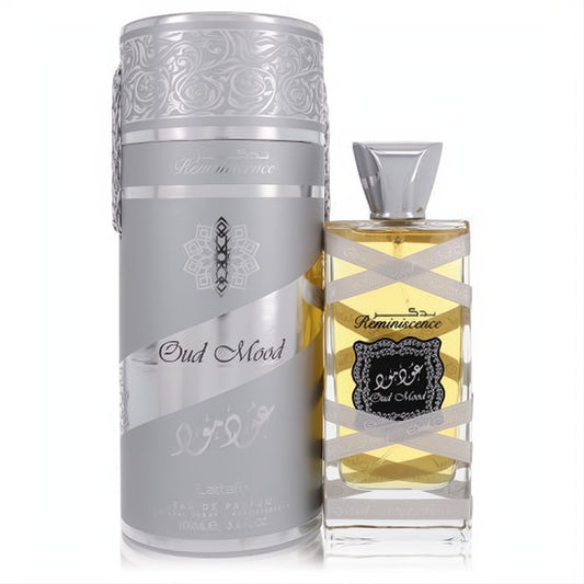 Luxurious Lattafa Oud Mood Reminiscence 3.4 oz unisex EDP. Silver embossed box and elegant clear glass bottle with golden liquid.