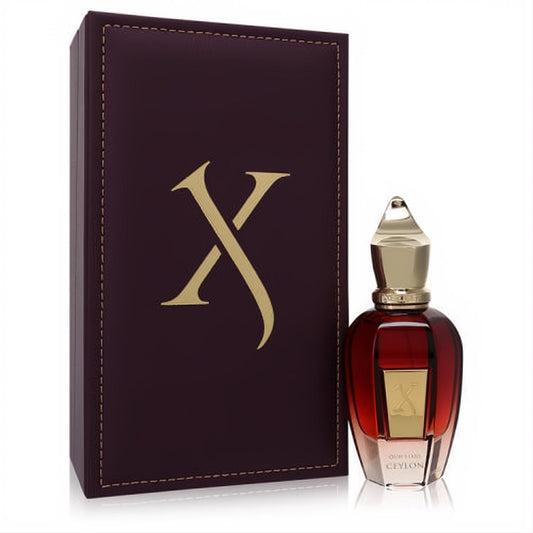 Luxurious Xerjoff Oud Stars Ceylon unisex perfume in an amber bottle with gold cap, next to its elegant burgundy box featuring a gold 'X' logo.