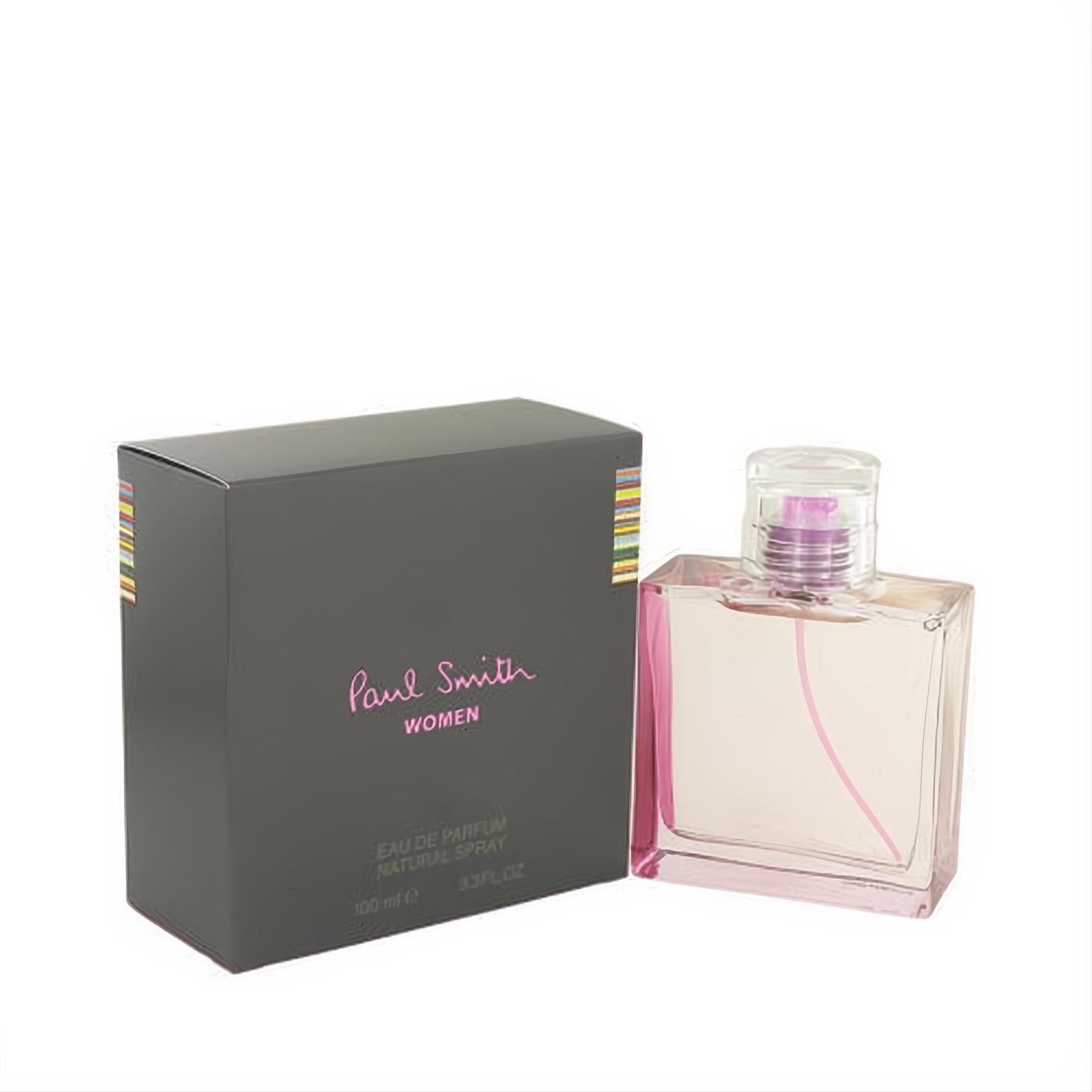 Experience Paul Smith WOMEN 3.4 oz Eau De Parfum. Elegant clear glass bottle with vibrant pink liquid, purple cap, and a chic dark grey box.