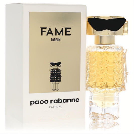 Paco Rabanne Fame 1 oz women's parfum. Gold liquid in a distinctive robot bottle with textured body, black sunglasses, and elegant white box.