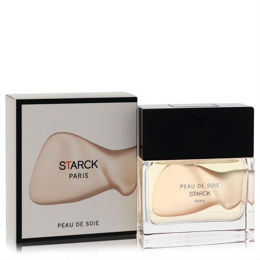 Chic Peau De Soie Starck Paris unisex EDT spray. Clear glass bottle with black cap, light beige liquid, and elegant white box.