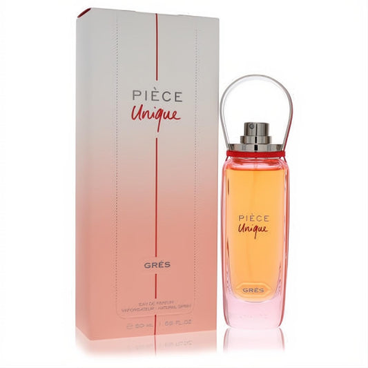 Piece Unique by Gres 1.69 oz EDP spray. Amber liquid in a sleek clear bottle with a unique handle cap, next to its elegant white box.