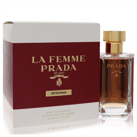 Luxurious Prada La Femme Intense 1.2 oz EDP spray, clear bottle, gold cap, and deep reddish-brown liquid, beside its elegant box.