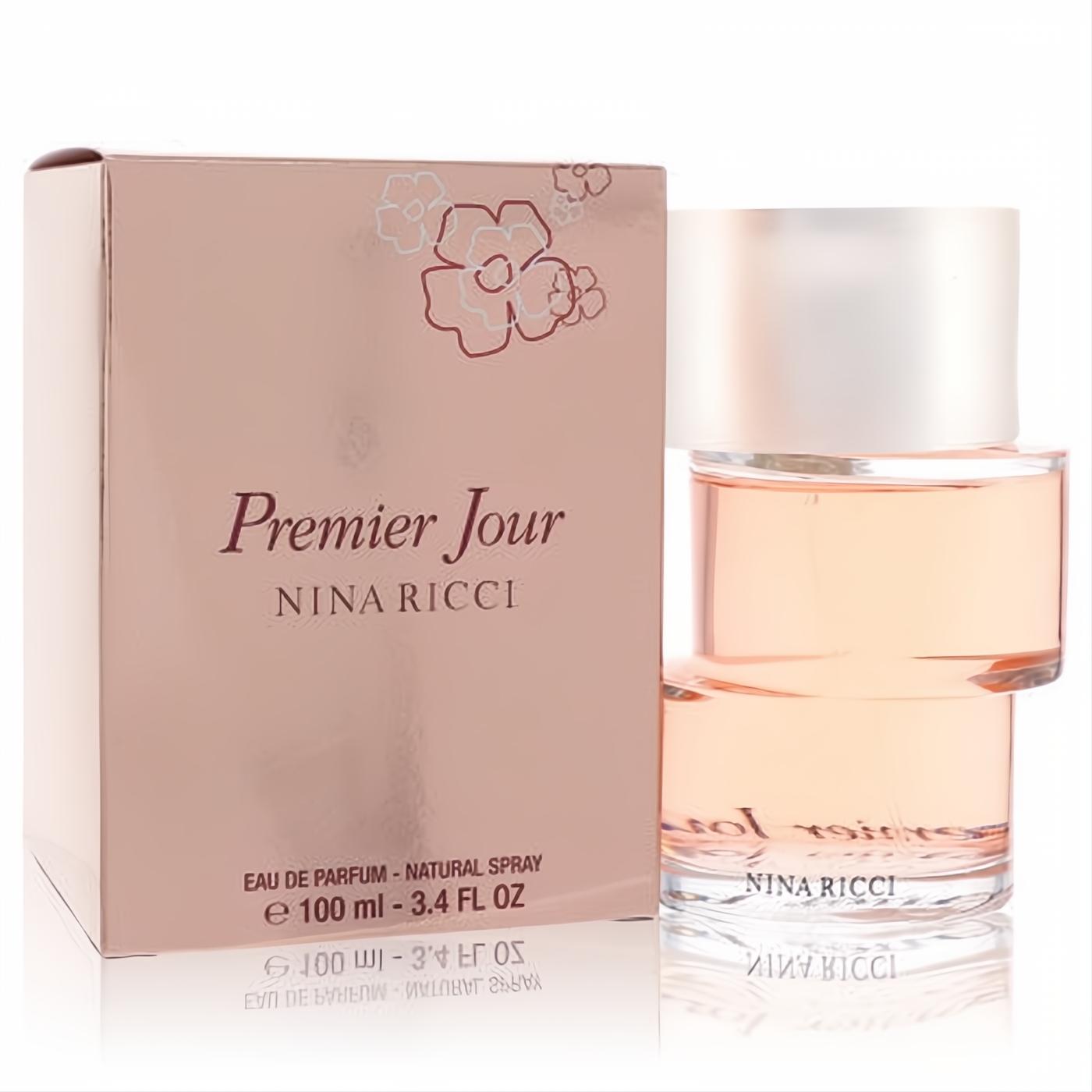 Premier Jour Nina Ricci 3.4 oz EDP. Elegant clear glass bottle with peach liquid, frosted cap, and rose gold box with floral design.