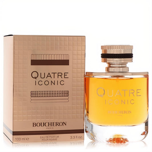 Boucheron Quatre Iconic 3.3 oz Eau De Parfum. Elegant golden amber fragrance bottle with a chic black and gold cap, beside a textured bronze box.