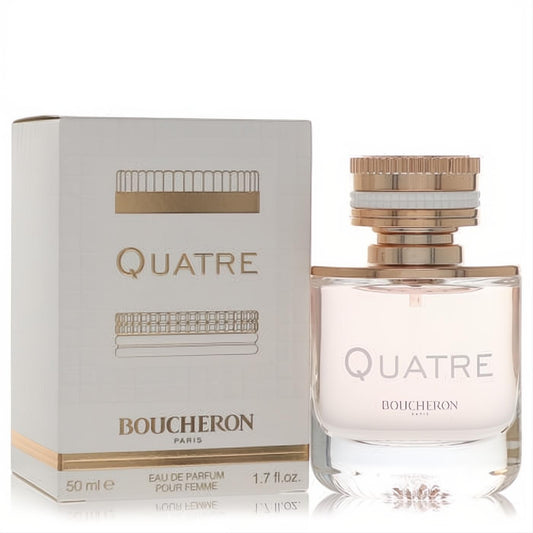 Elegant Boucheron Quatre Eau De Parfum, 1.7 oz, in a clear bottle with a distinctive rose gold cap, next to its chic white and gold box.