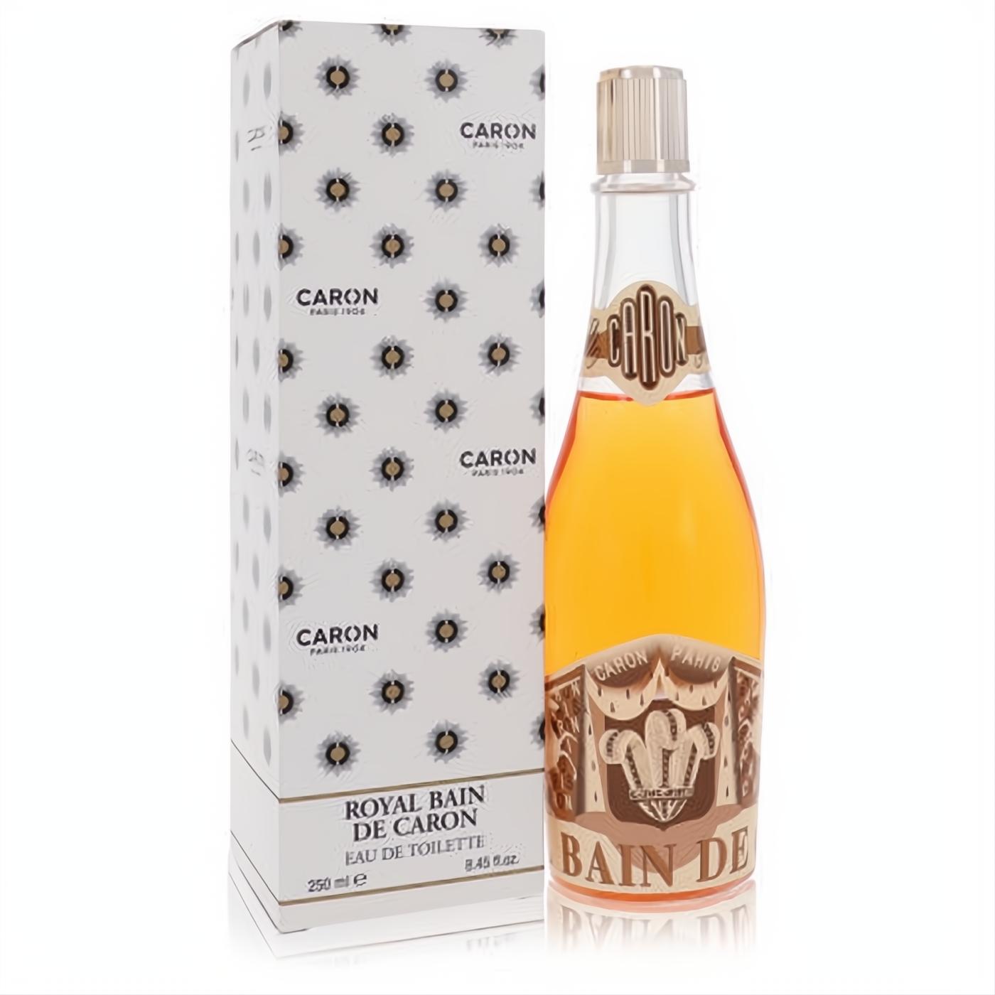 Luxurious Caron Royal Bain Champagne 8.45 oz EDT. Golden liquid in a clear, ornate glass bottle with gold cap, beside its elegant white patterned box.
