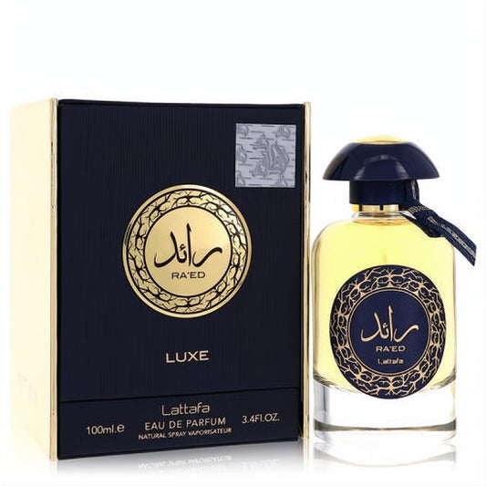 Raed Luxe Gold Lattafa 3.4 oz unisex Eau De Parfum. Elegant clear glass bottle with dark blue cap and luxurious dark blue and gold box.