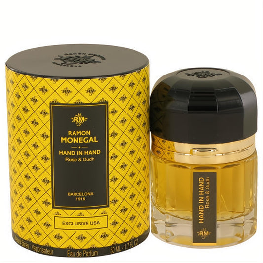 Ramon Monegal Hand in Hand Rose & Oud 1.7 oz EDP. Elegant faceted glass bottle, black cap, and distinctive yellow patterned box.