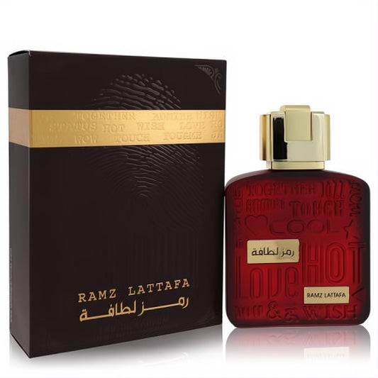 Ramz Lattafa Gold unisex Eau De Parfum. Bold dark red glass bottle with gold cap and matching brown textured box.