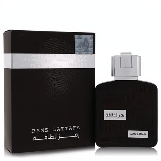 Elegant Ramz Lattafa 3.4 oz men's EDP. Sleek black bottle with textured design, silver cap, and matching black box with fingerprint.