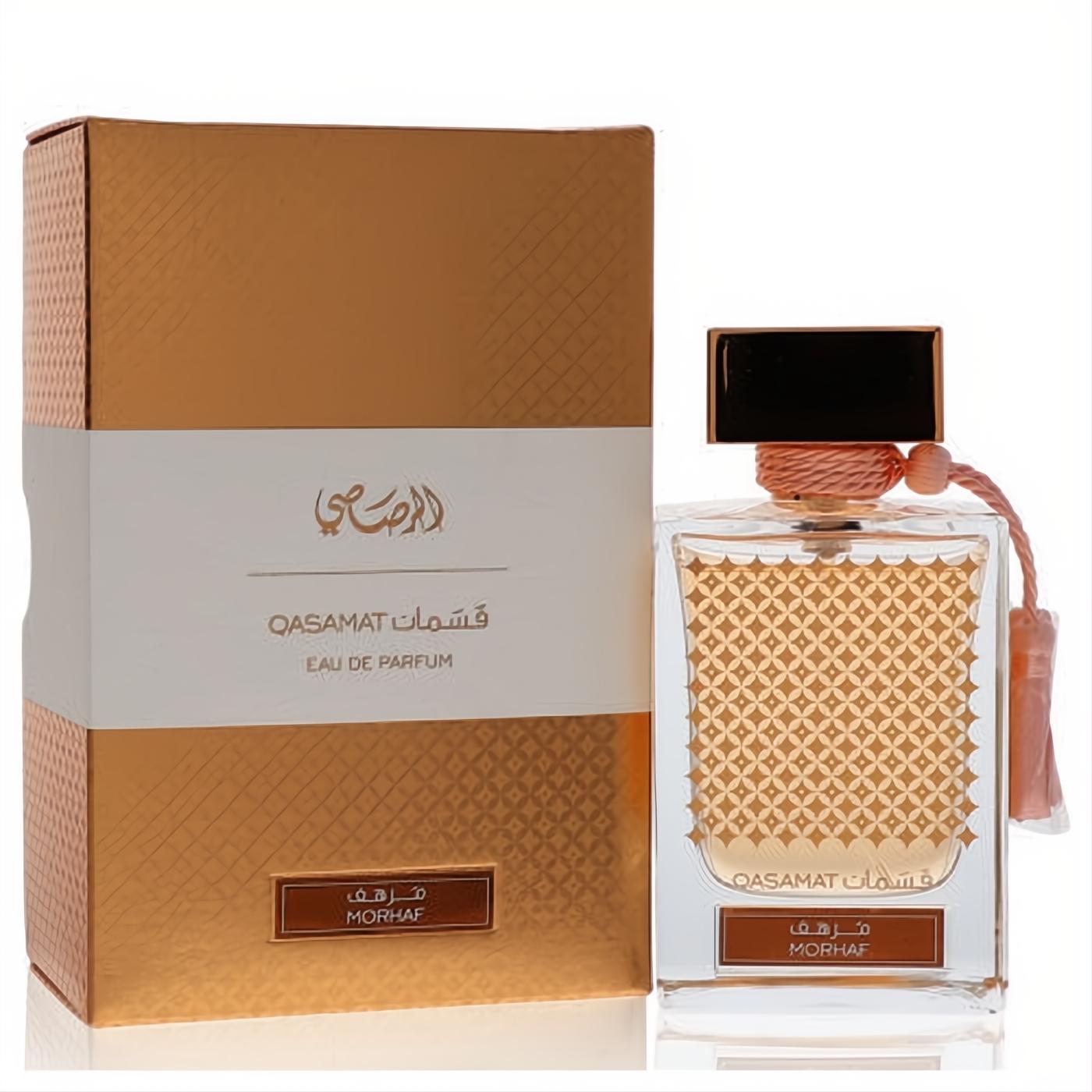 Rasasi Qasamat Morhaf unisex EDP: clear bottle with gold liquid, intricate pattern, peach tassel, and elegant gold box.