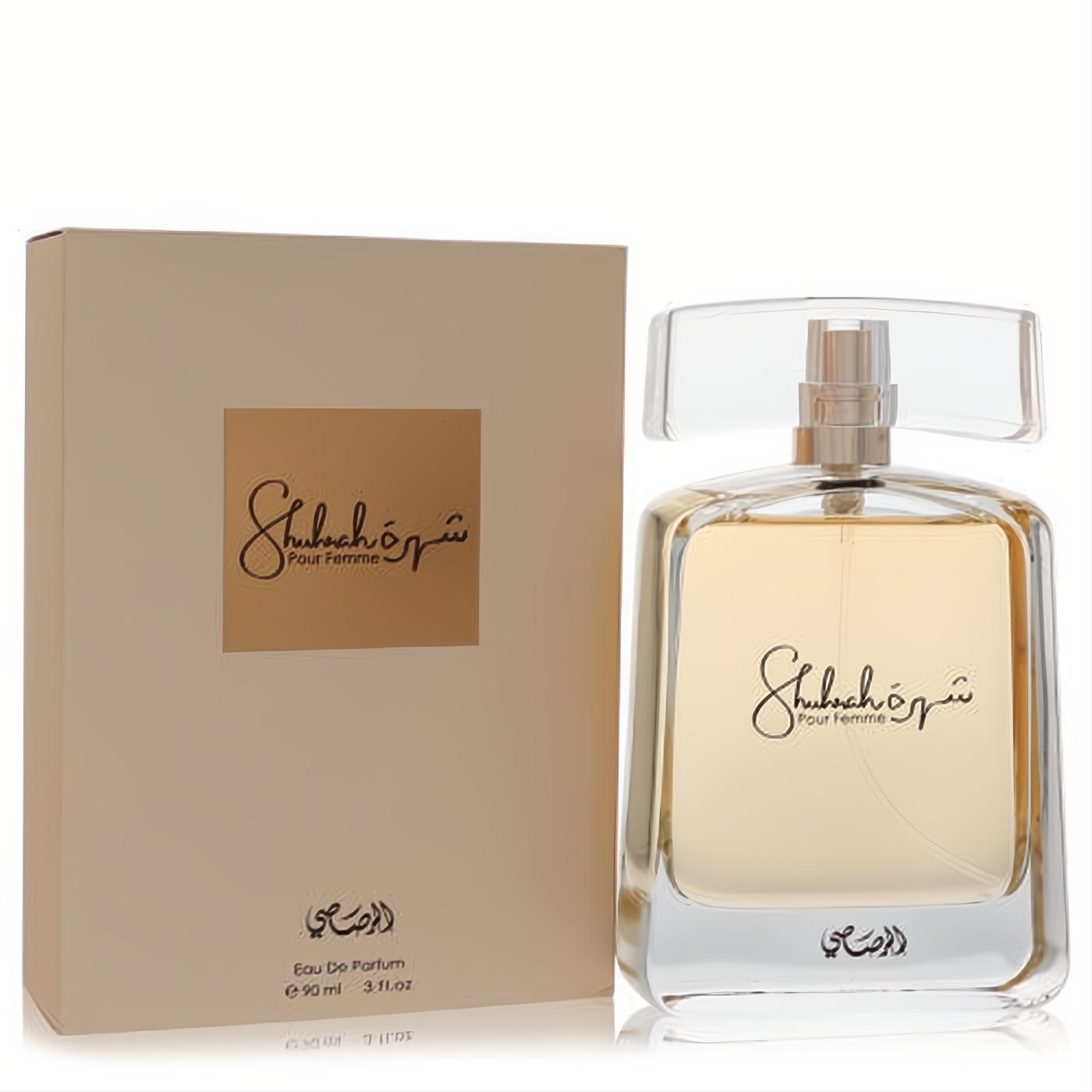 Discover Rasasi Shuhrah 90ml women's Eau De Parfum. Elegant clear glass bottle with golden liquid, alongside its chic beige box.