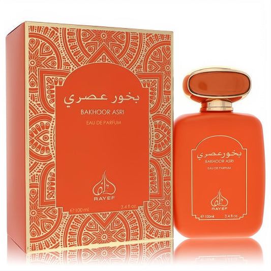 Rayef Bakhoor Al Asri 3.4 oz unisex EDP. Matte orange bottle with gold cap, beside an ornate gold-patterned box.